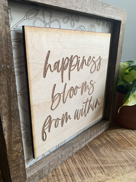 Happiness Blooms Within Layered Sign